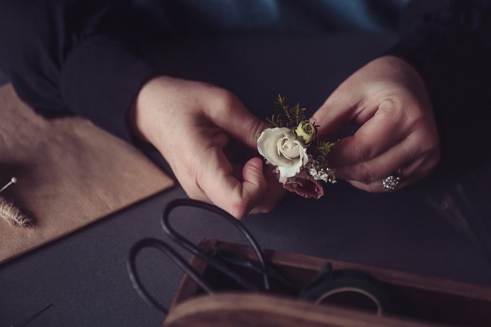 Hand crafted delicate buttonhole of rosebuds tied with jute string 