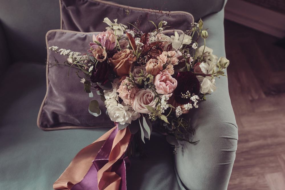 Bridal bouquet of spring flowers tied with silk ribbons 